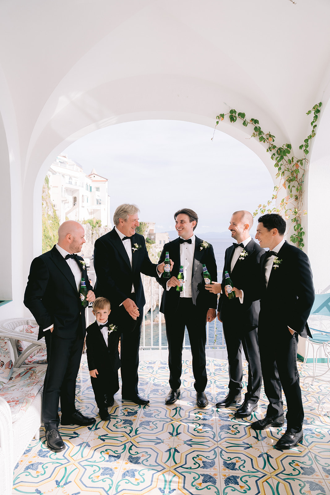 Andrea Gallucci - Destination Wedding Photographer- Amalfi Coast Positano Santorini Barcellona Rome Ravello Paris New York groom and his groomsmen drinking before the start of the big day