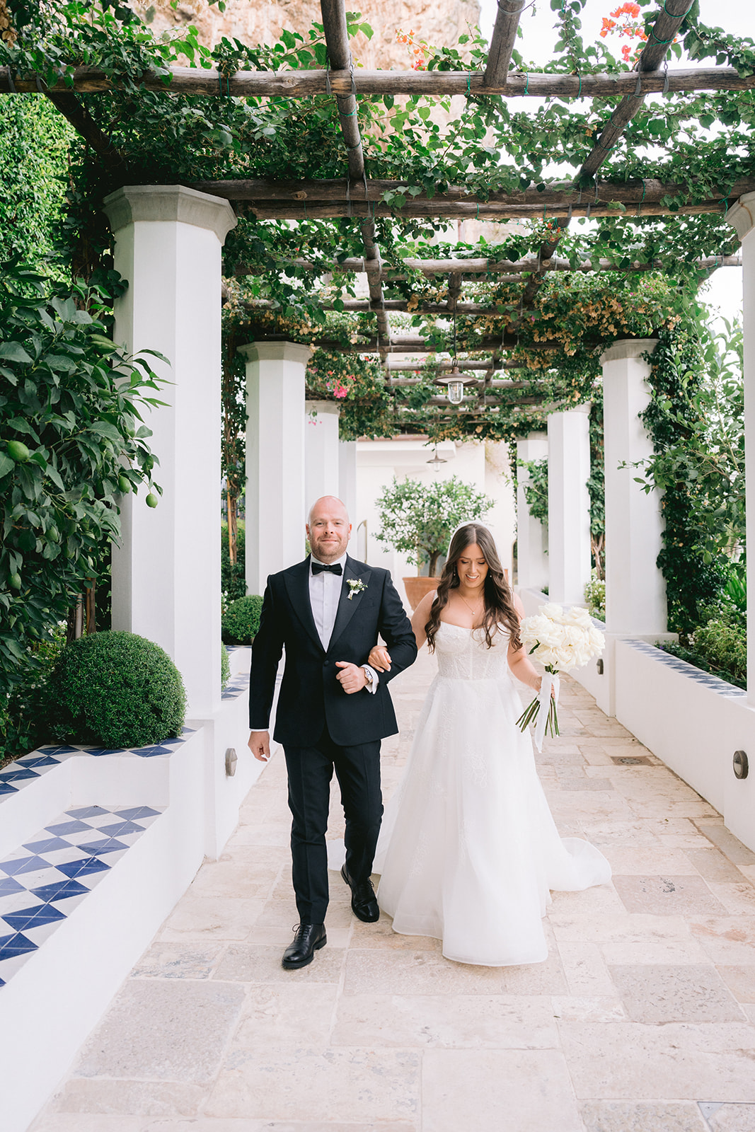 Andrea Gallucci - Destination Wedding Photographer- Amalfi Coast Positano Santorini Barcellona Rome Ravello Paris New York bride walking with bother for the wedding ceremony