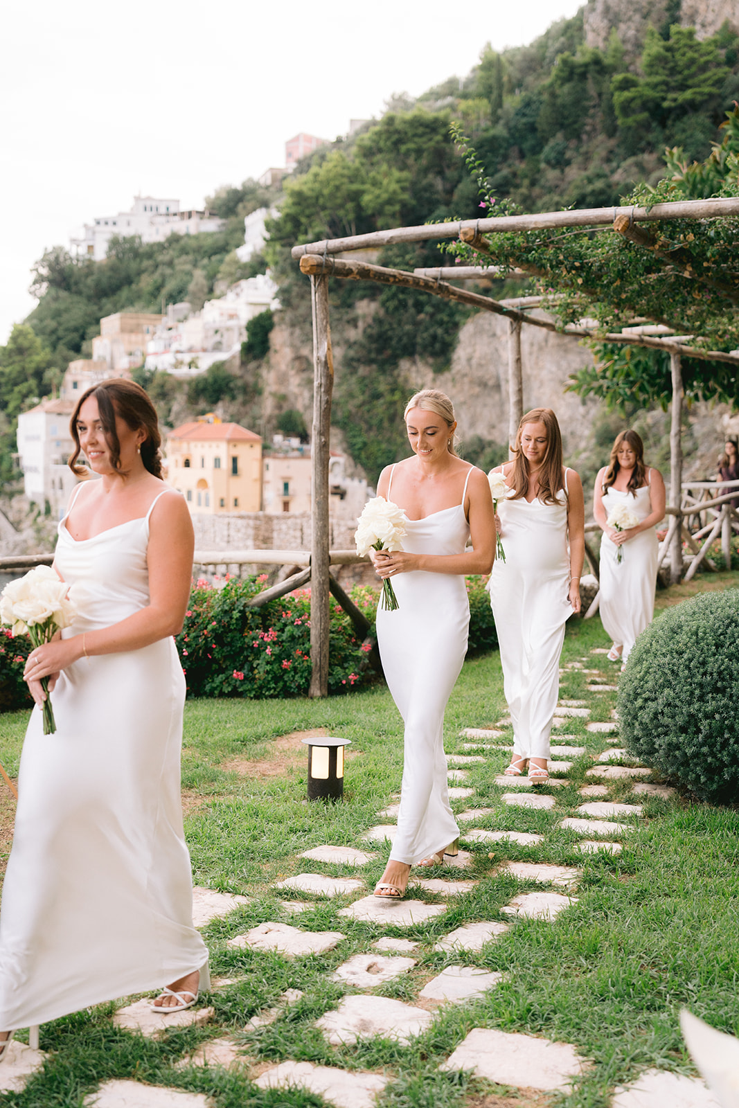 Andrea Gallucci - Destination Wedding Photographer- Amalfi Coast Positano Santorini Barcellona Rome Ravello Paris New York bridesmaids walking the aisle during outdoor wedding ceremony