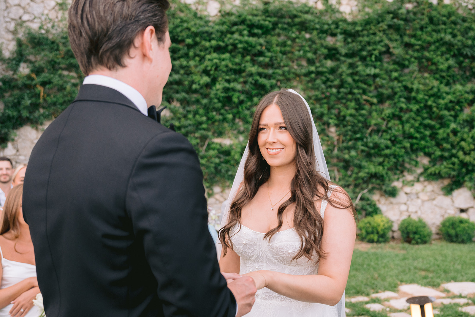 Andrea Gallucci - Destination Wedding Photographer- Amalfi Coast Positano Santorini Barcellona Rome Ravello Paris New York groom putting the ring ont he bride during outdoor wedding ceremony