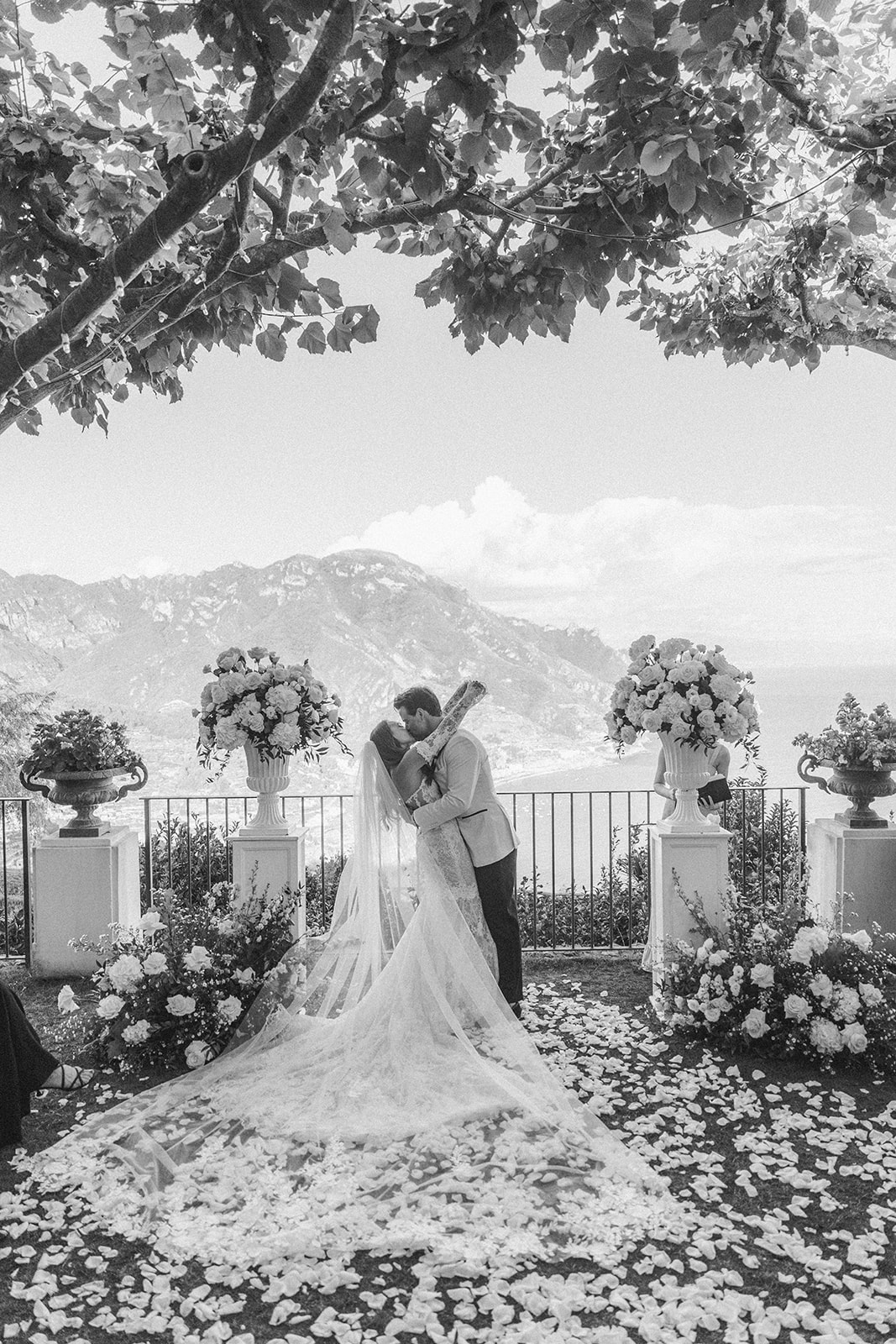 Andrea Gallucci - Destination Wedding Photographer- Amalfi Coast Positano Santorini Barcellona Rome Ravello Paris New York timeless wedding photo of the bride and groom first kiss
