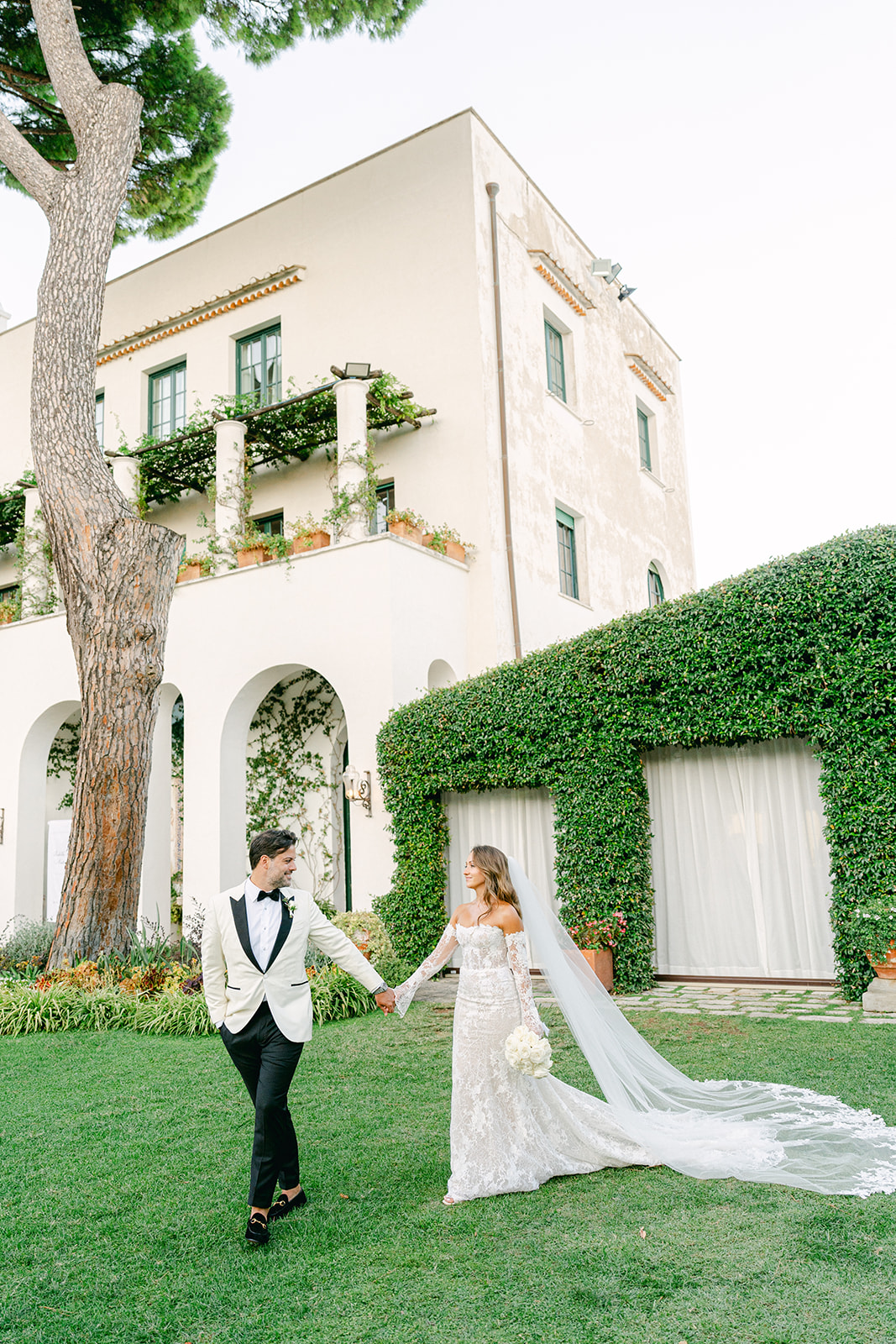 Andrea Gallucci - Destination Wedding Photographer- Amalfi Coast Positano Santorini Barcellona Rome Ravello Paris New York Bride and groom walking off in their wedding venue, Villa Eva