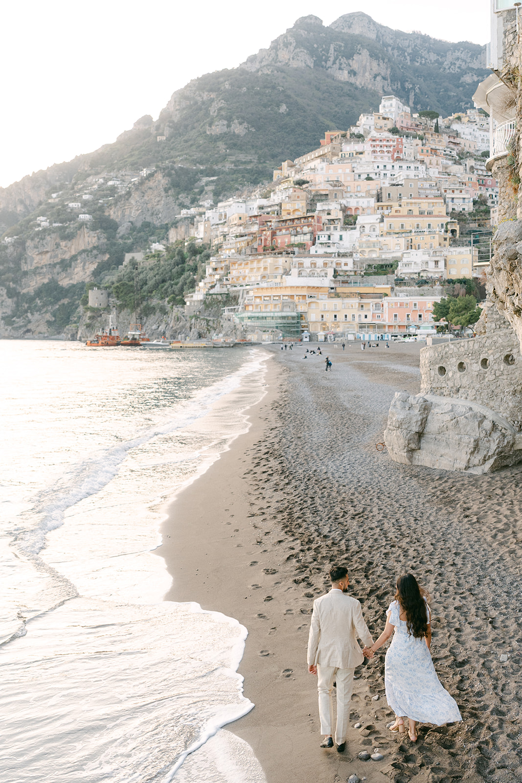 Andrea Gallucci - Destination Wedding Photographer- Amalfi Coast Positano Santorini Barcellona Rome Ravello Paris New York couple walking on the beach for engagement photo