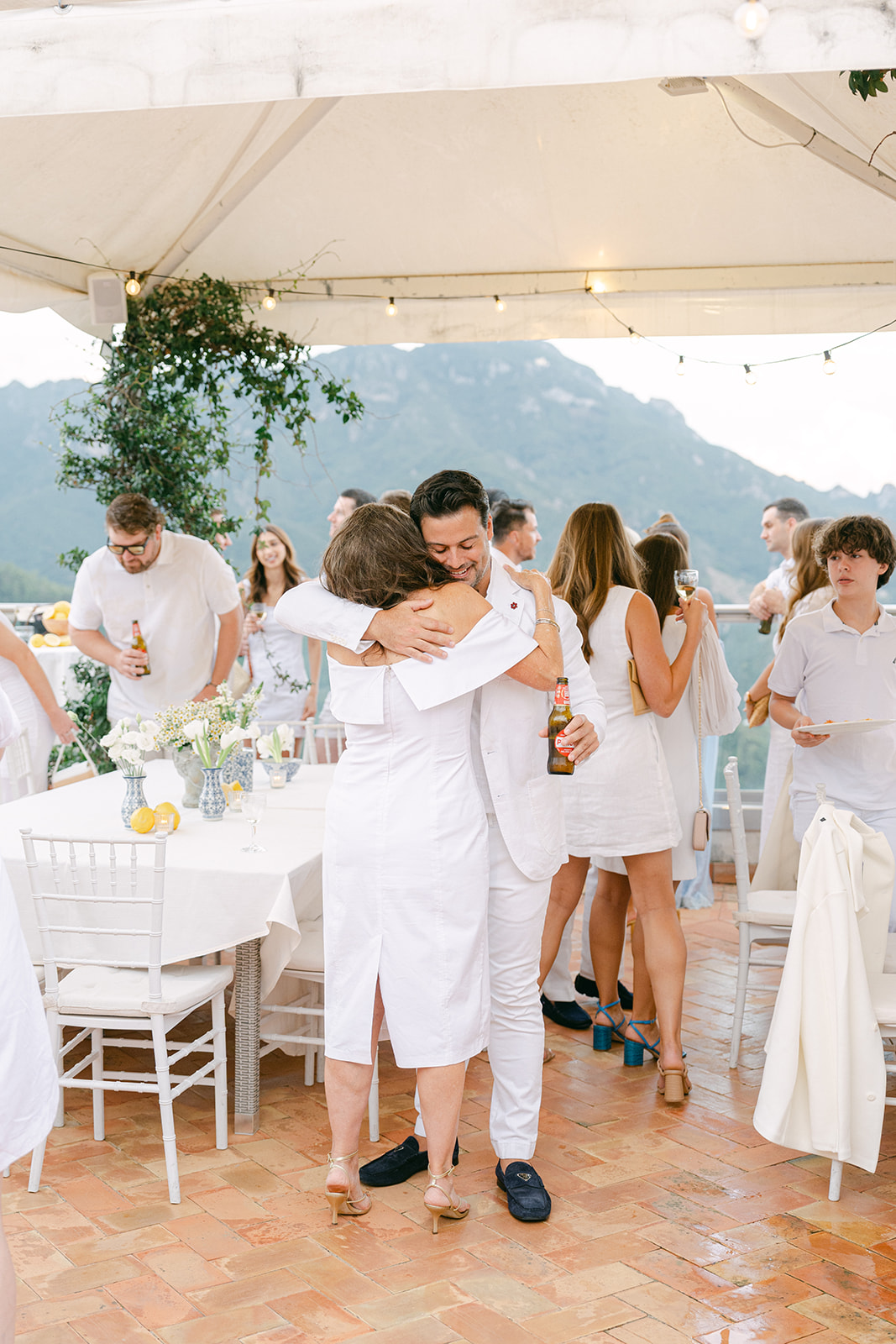 Andrea Gallucci - Destination Wedding Photographer- Amalfi Coast Positano Santorini Barcellona Rome Ravello Paris New York documentary wedding photo of groom hugging guest