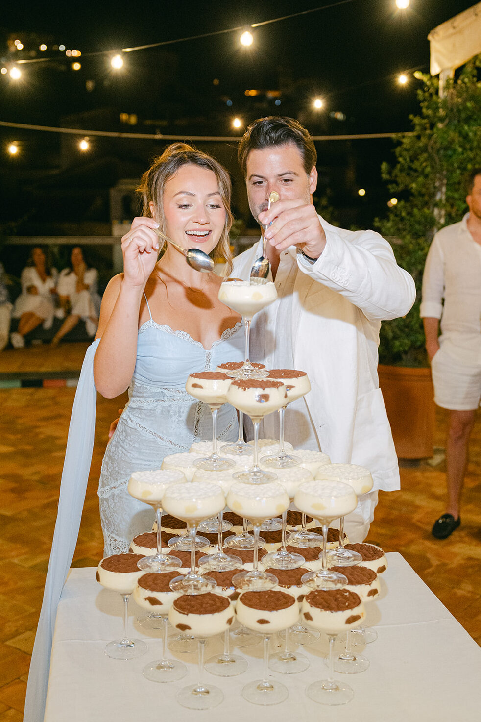 Andrea Gallucci - Destination Wedding Photographer- Amalfi Coast Positano Santorini Barcellona Rome Ravello Paris New York bride and groom digging in their tiramisu tower