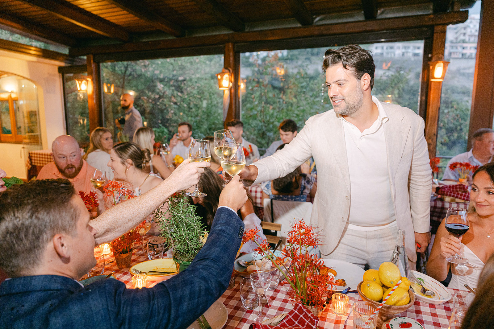 Andrea Gallucci - Destination Wedding Photographer- Amalfi Coast Positano Santorini Barcellona Rome Ravello Paris New York groom toasting with the guests for rehearsal dinner