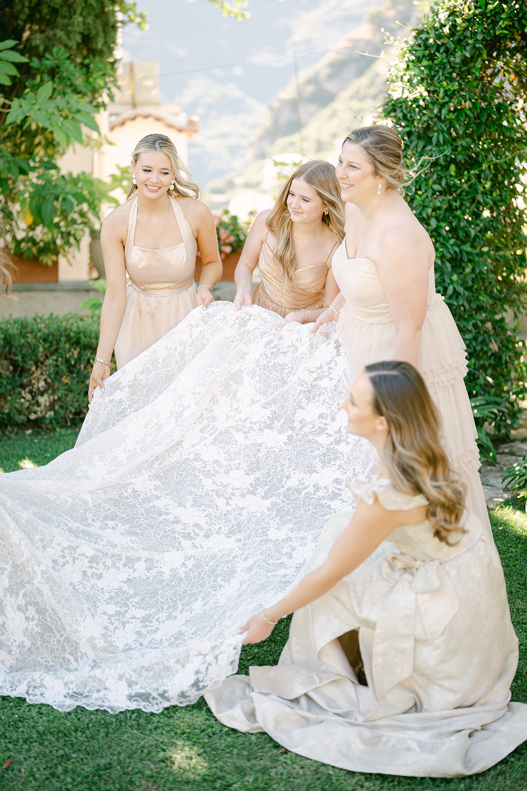 Andrea Gallucci - Destination Wedding Photographer- Amalfi Coast Positano Santorini Barcellona Rome Ravello Paris New York the bridesmaids holding the bride's dress