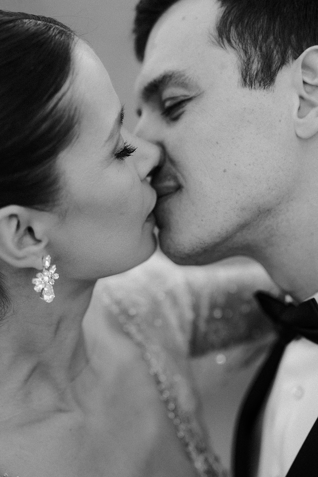 timeless portrait of bride and groom sharing a kiss
