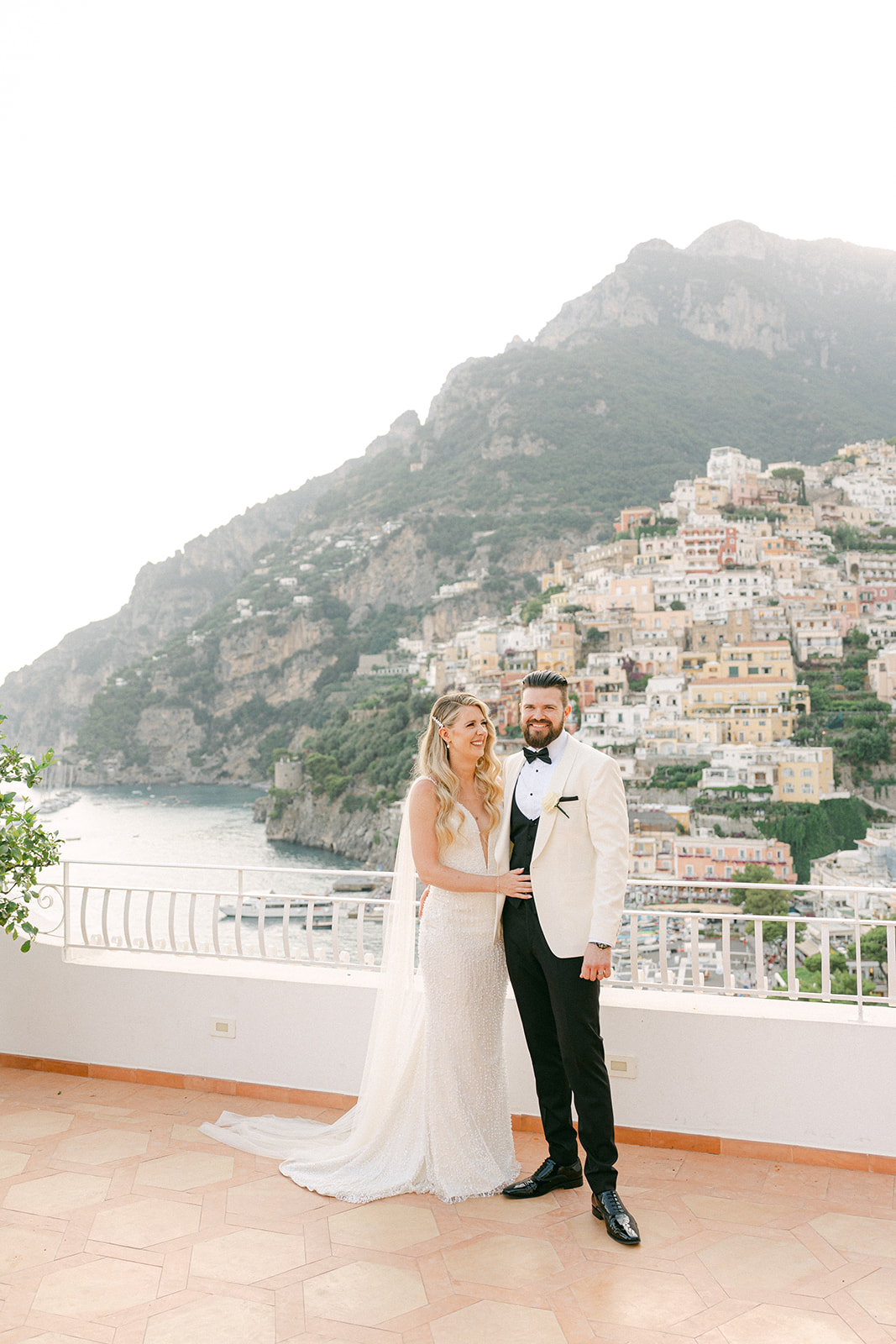 Andrea Gallucci - Destination Wedding Photographer- Amalfi Coast Positano Santorini Barcellona Rome Ravello Paris New York Scenic Positano view with bride and groom in the foreground