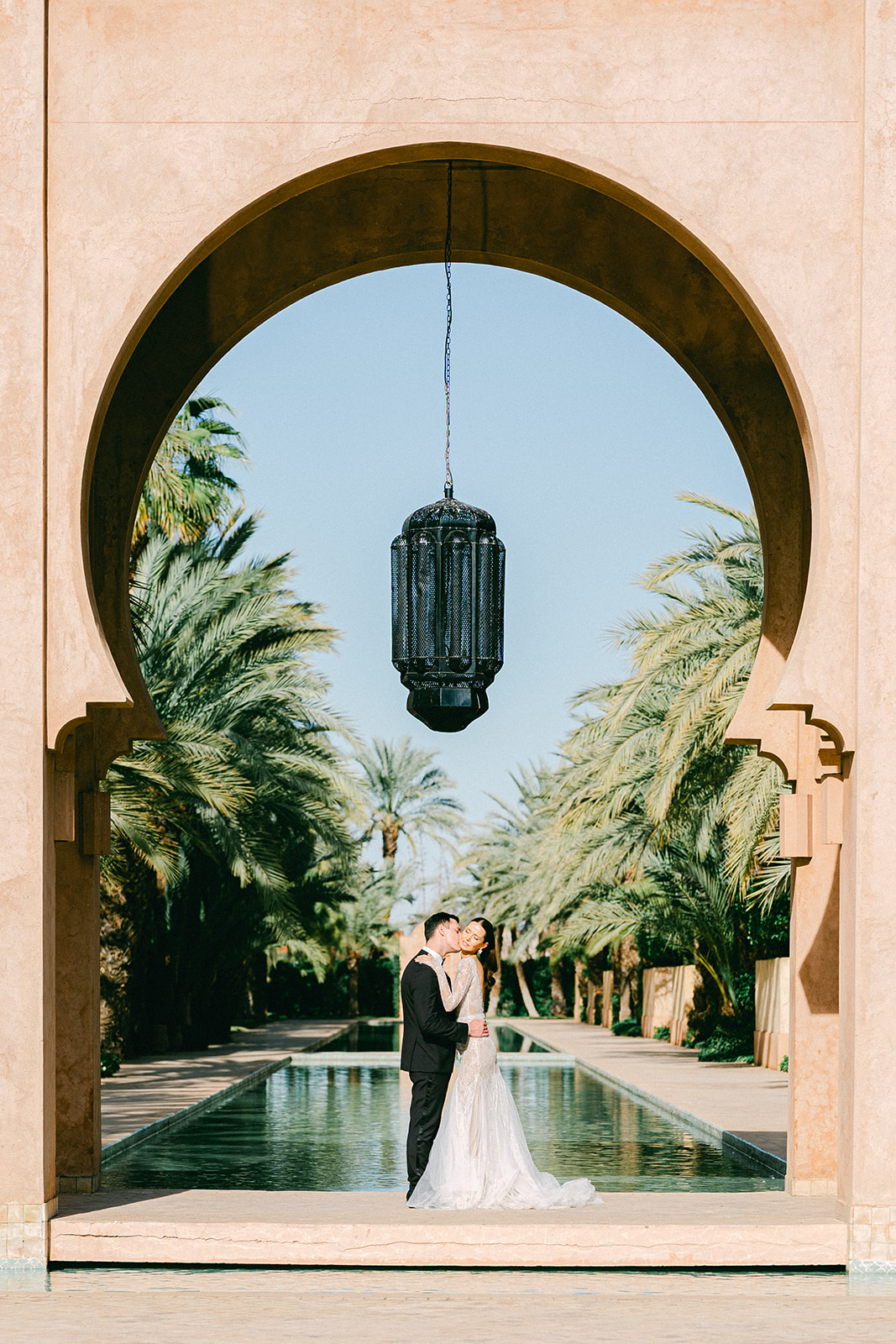 Elegant Morocco wedding couple poses at Amanjena