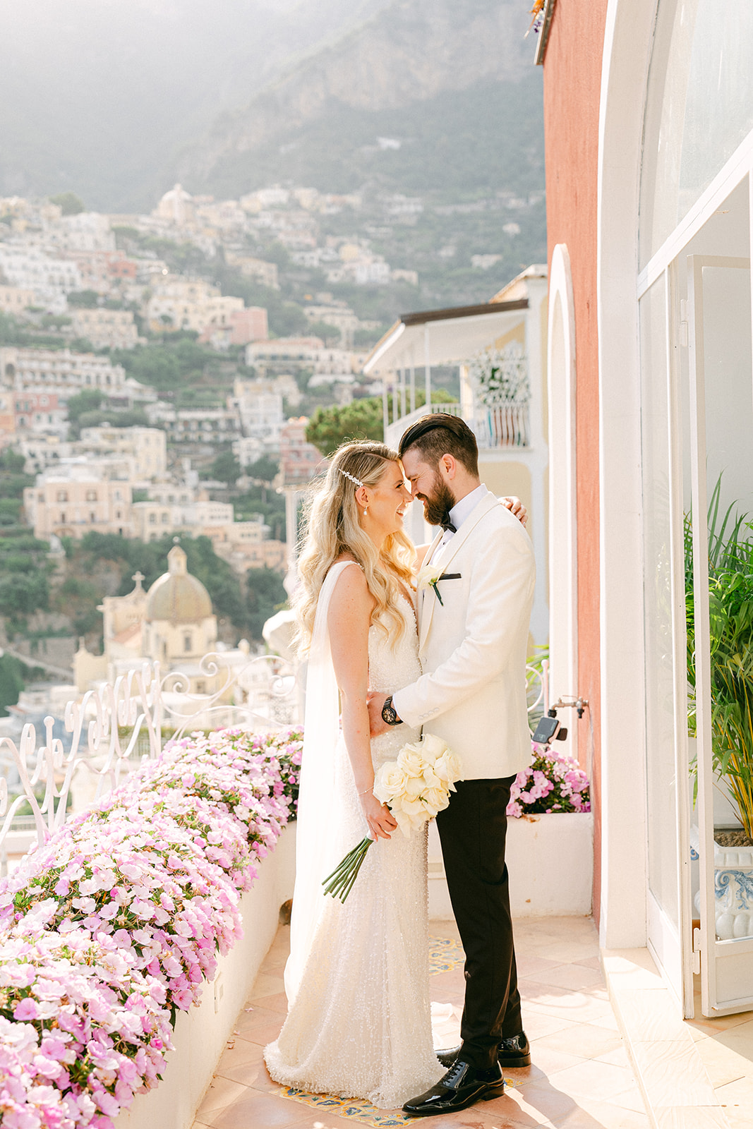 Andrea Gallucci - Destination Wedding Photographer- Amalfi Coast Positano Santorini Barcellona Rome Ravello Paris New York Candid moment of newlyweds with Positano cliffside behind them