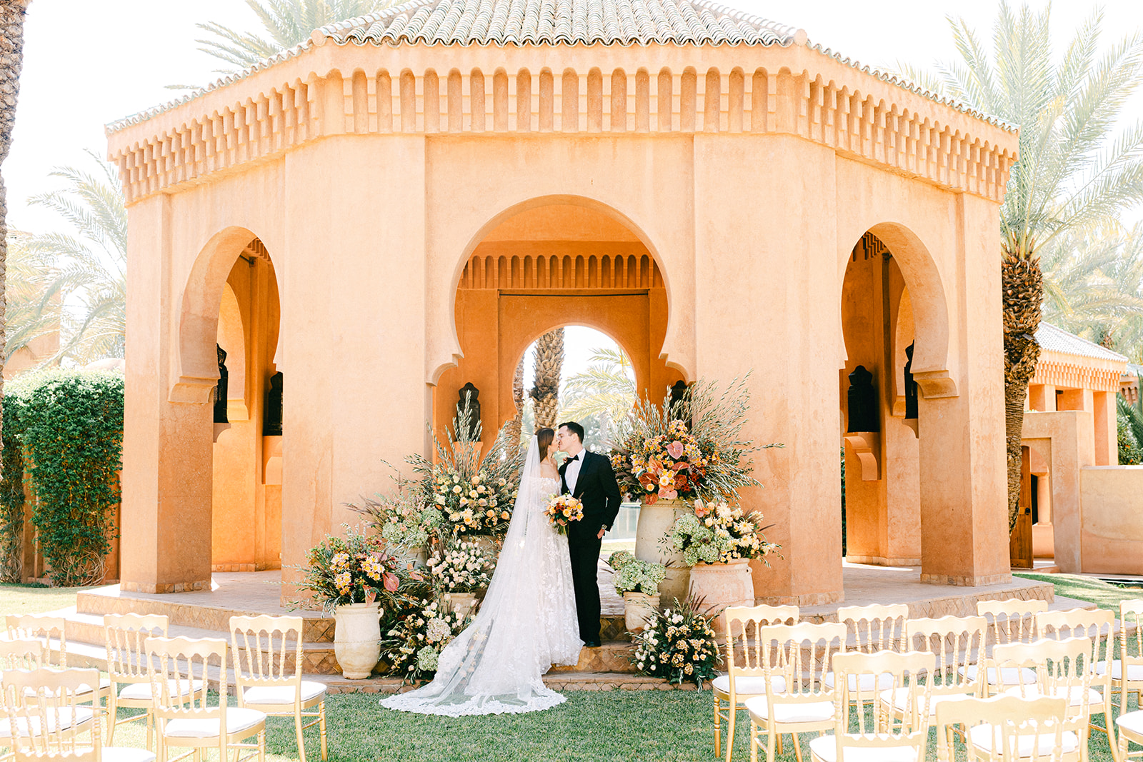Outdoor wedding setup at Amanjena featuring Moroccan-style decor and natural greenery