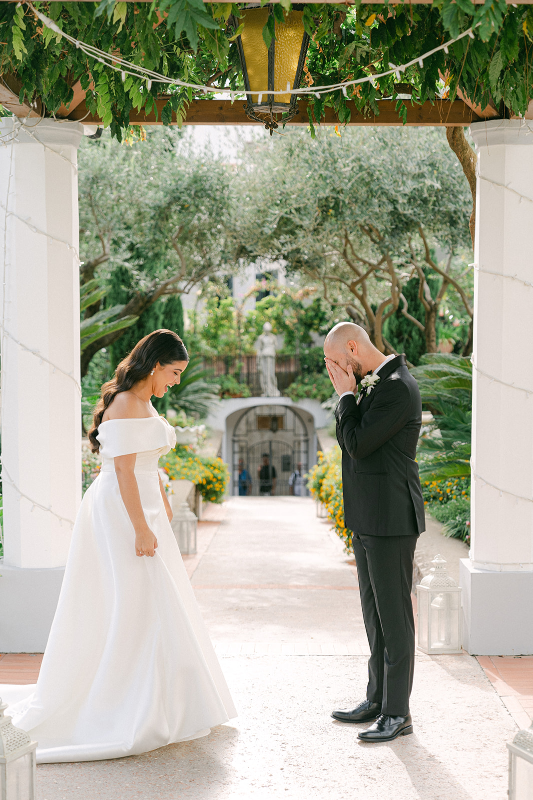 Groom wiping away tears during first look moment at an Italy wedding