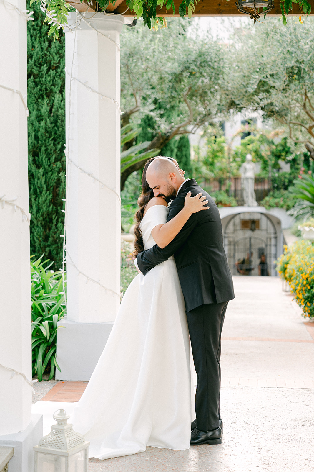 Candid Italian wedding photographer moment of bride and groom hugging after first look