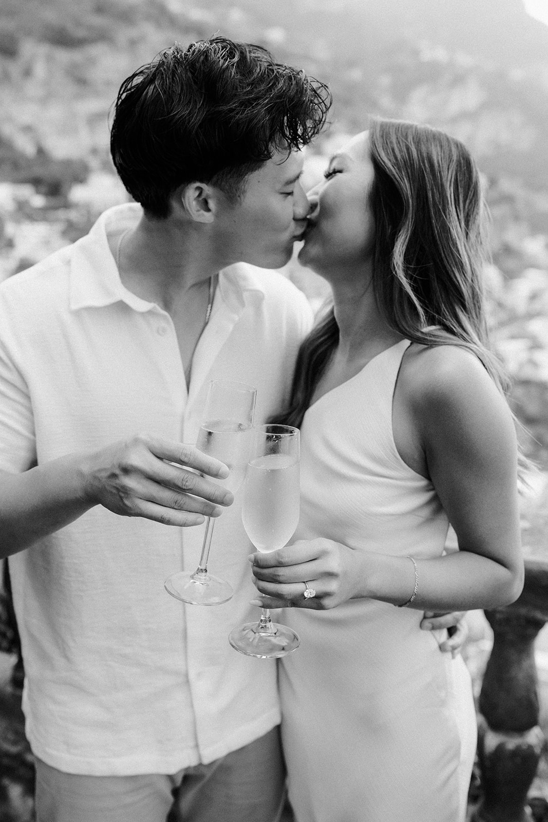 Romantic kiss during outdoor engagement photos on the beach in Amalfi