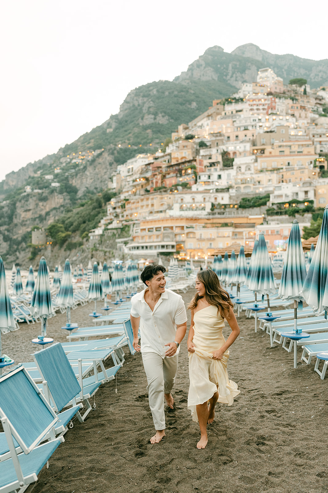 Couple enjoying outdoor engagement photos on the Amalfi Coast at golden hour