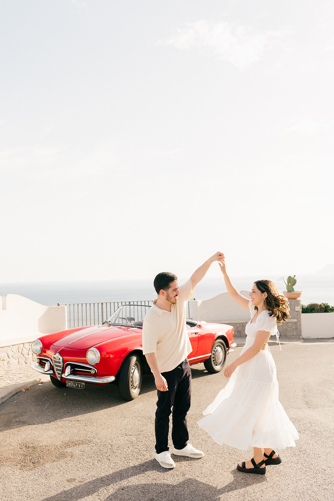 Outdoor engagement photos with vintage Italian car  backdrop in Amalfi Coast