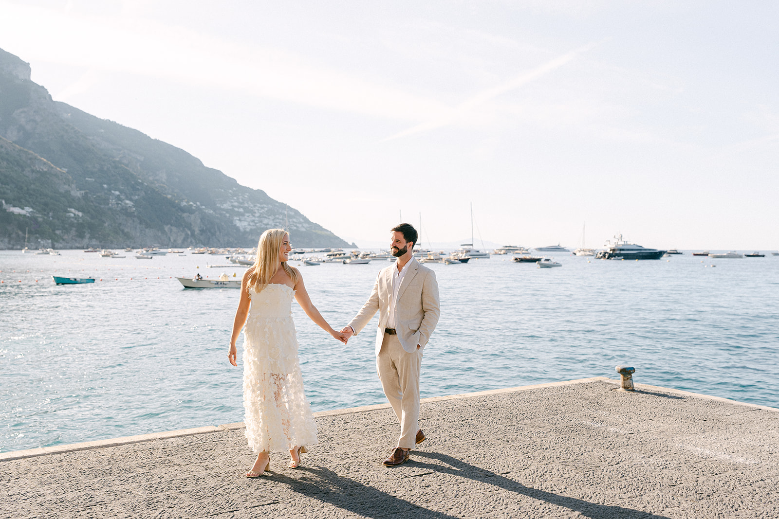 Natural candid outdoor engagement photos with Amalfi Coast ocean backdrop