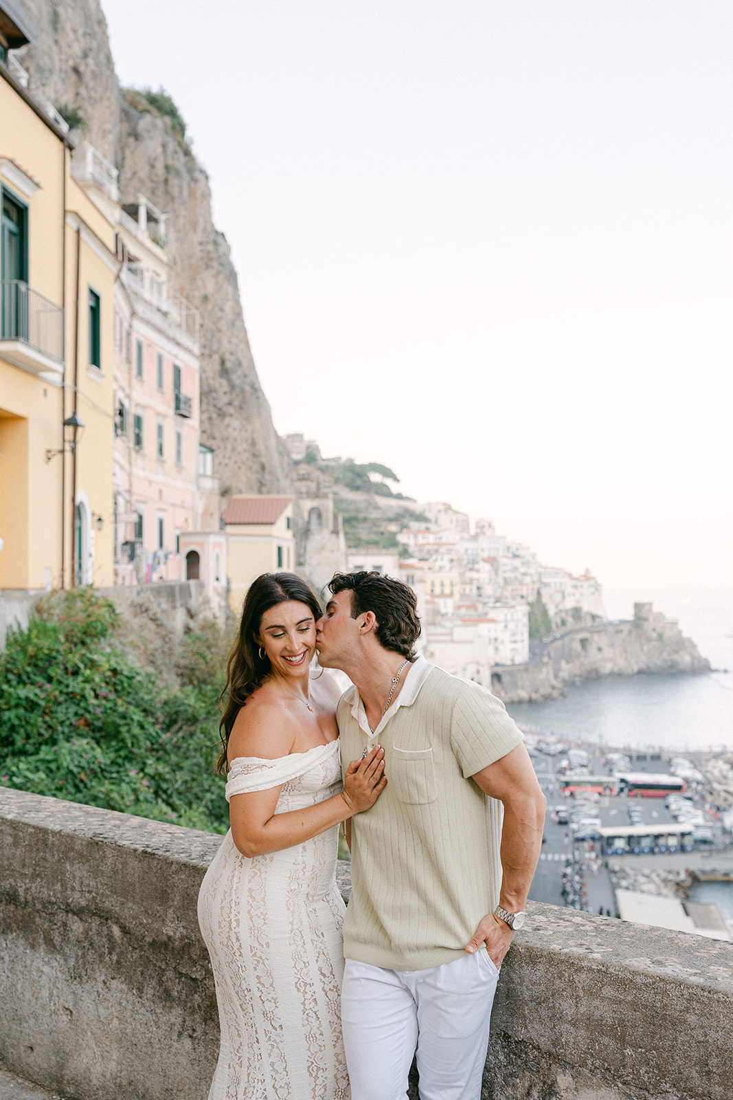 Bride and groom-to-be portraits with cliffs in the background in Amalfi