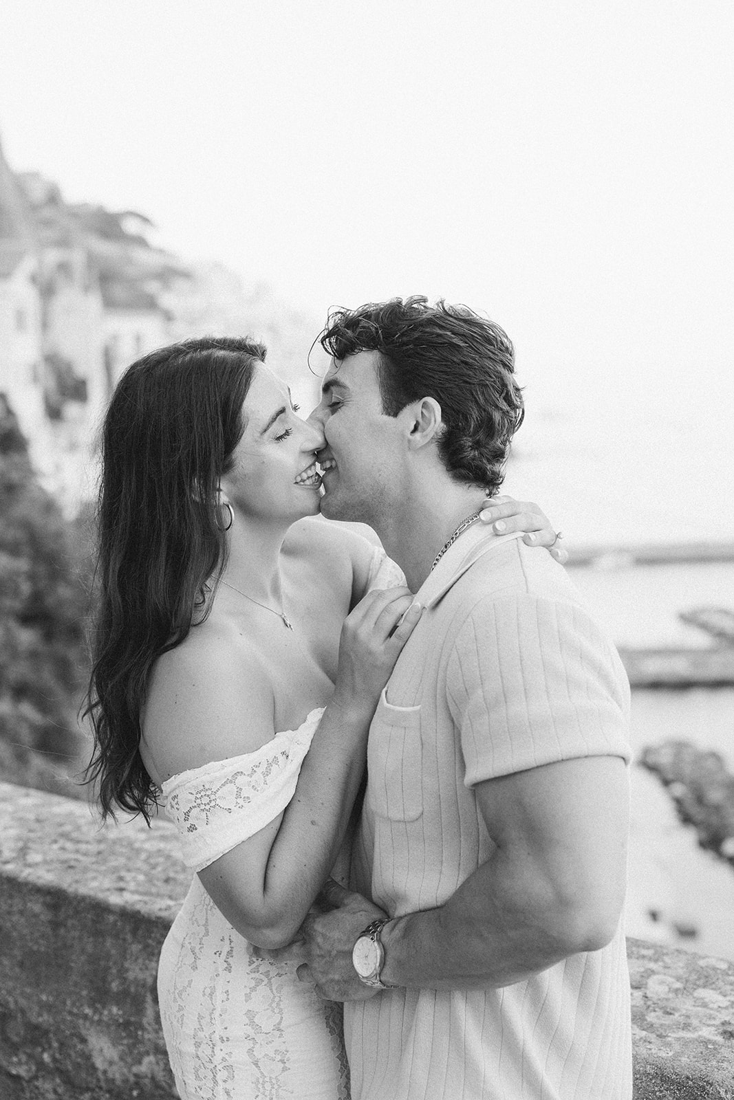 Couple sharing a kiss during outdoor engagement photos in Italy