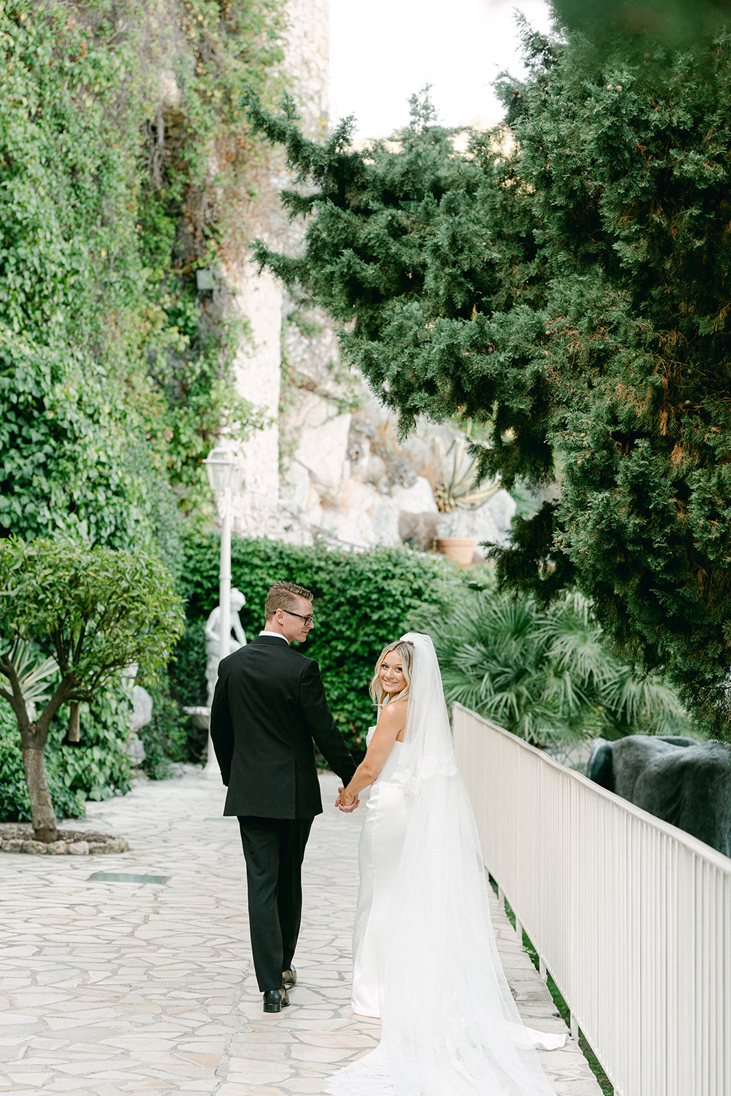 Couple walking through the gardens of Château de la Chèvre d’Or, France