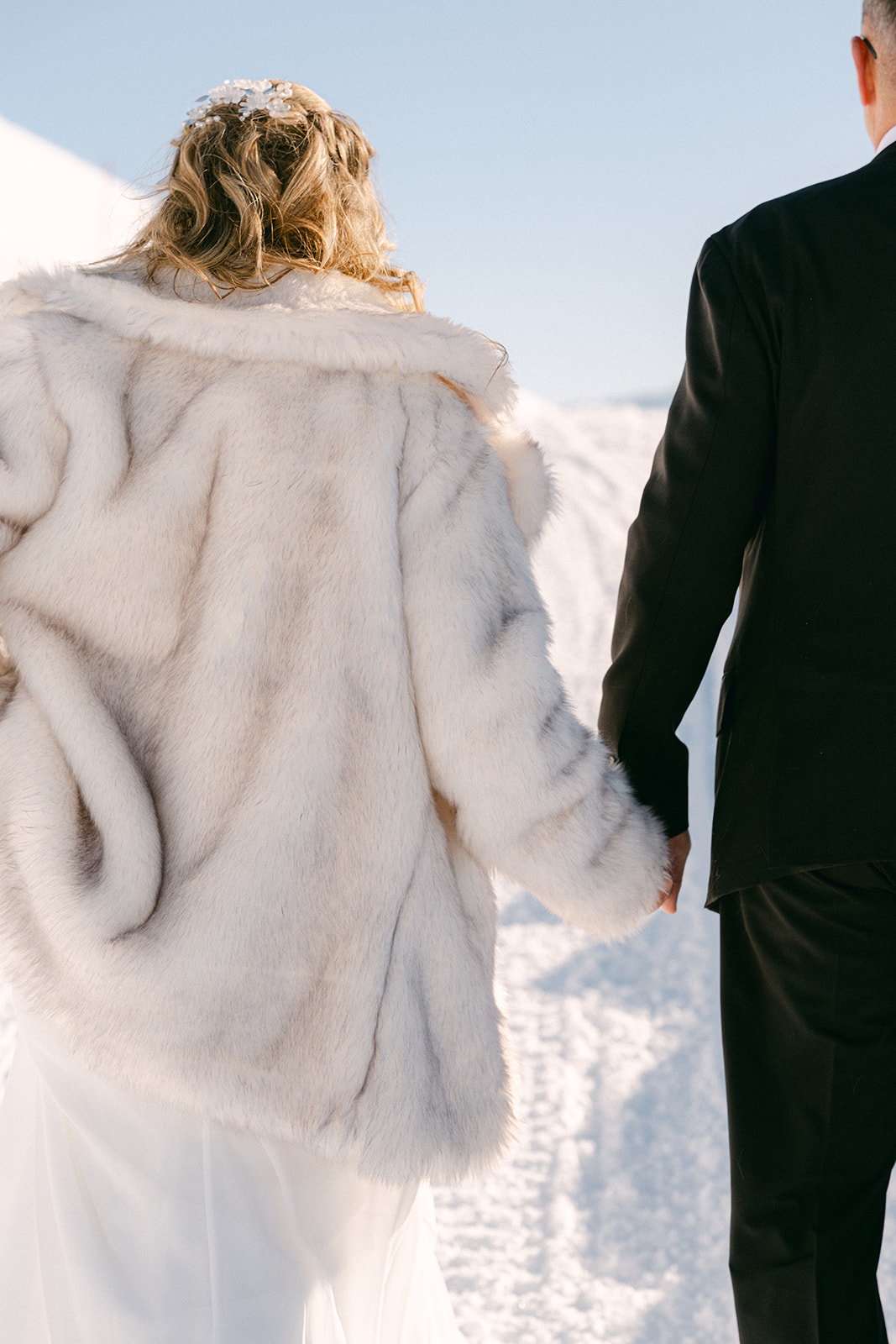 bride and groom walking holding hands