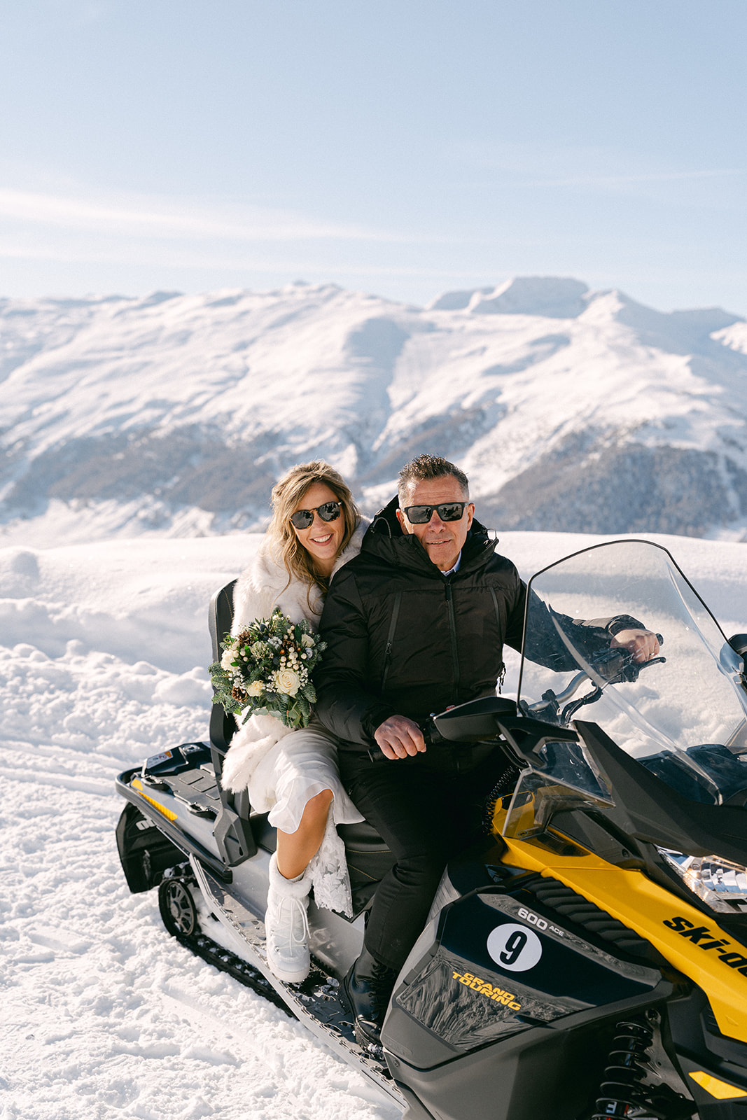 Bride and groom portraits on a snowmobile