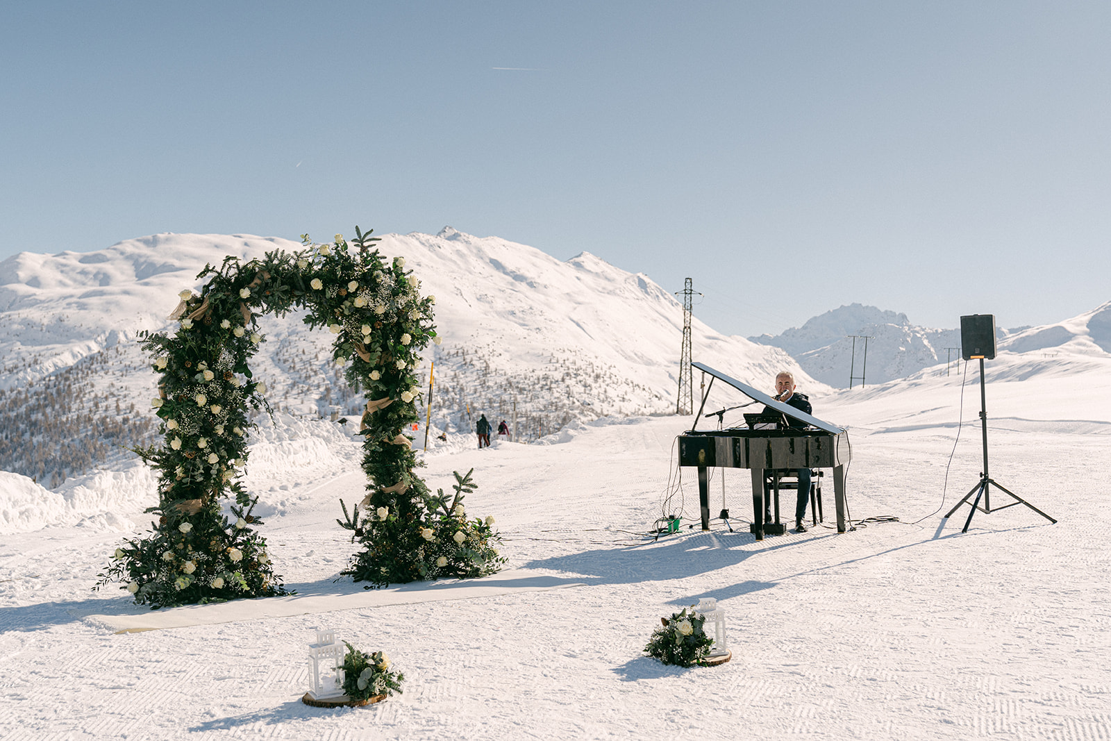 outdoor wedding ceremony with floral arch and a private piano man