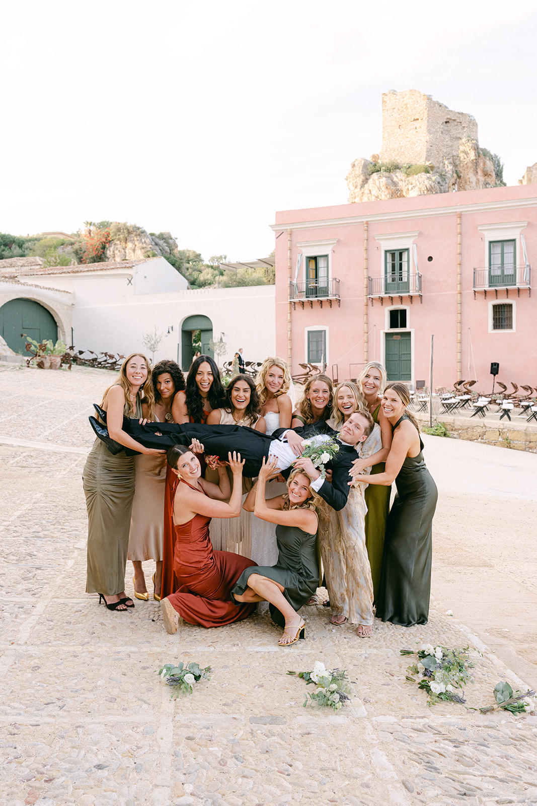 fun wedding photos of bridesmaids carrying the groom