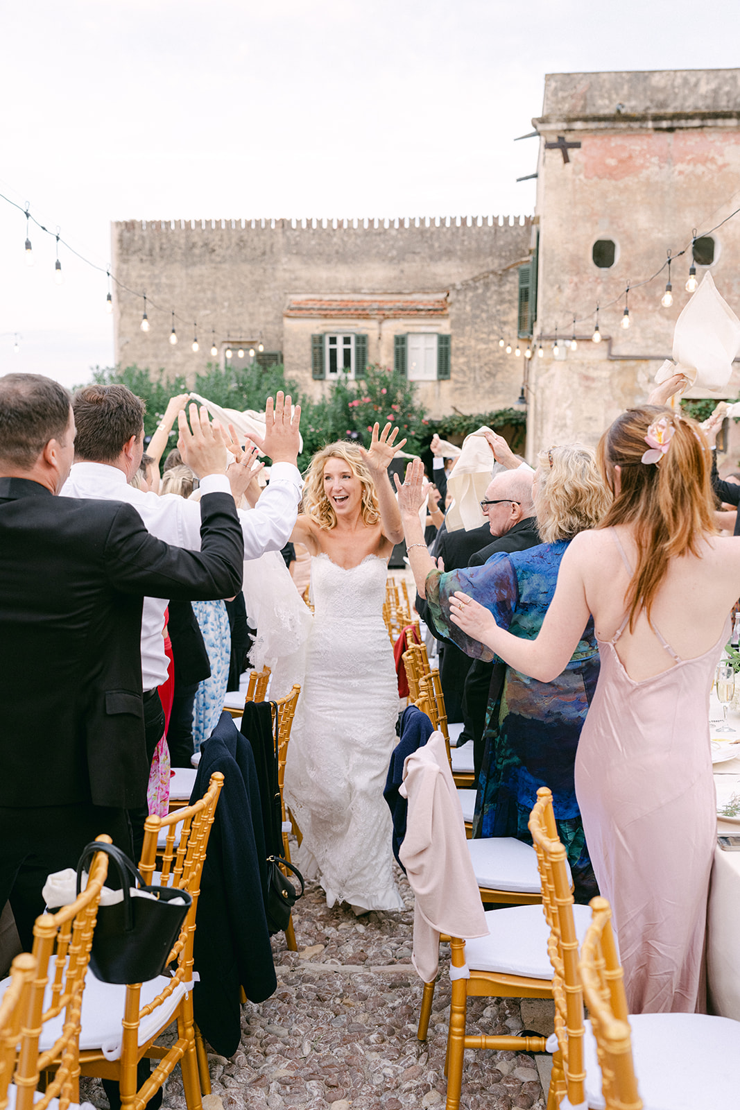 bride entering the wedding reception dancing through the guests table