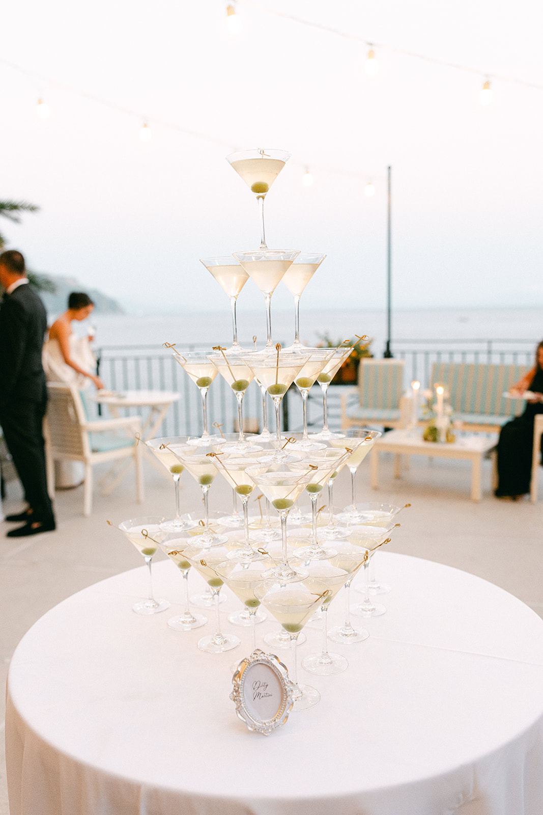 Luxury wedding celebration with an elevated dirty martini tower.