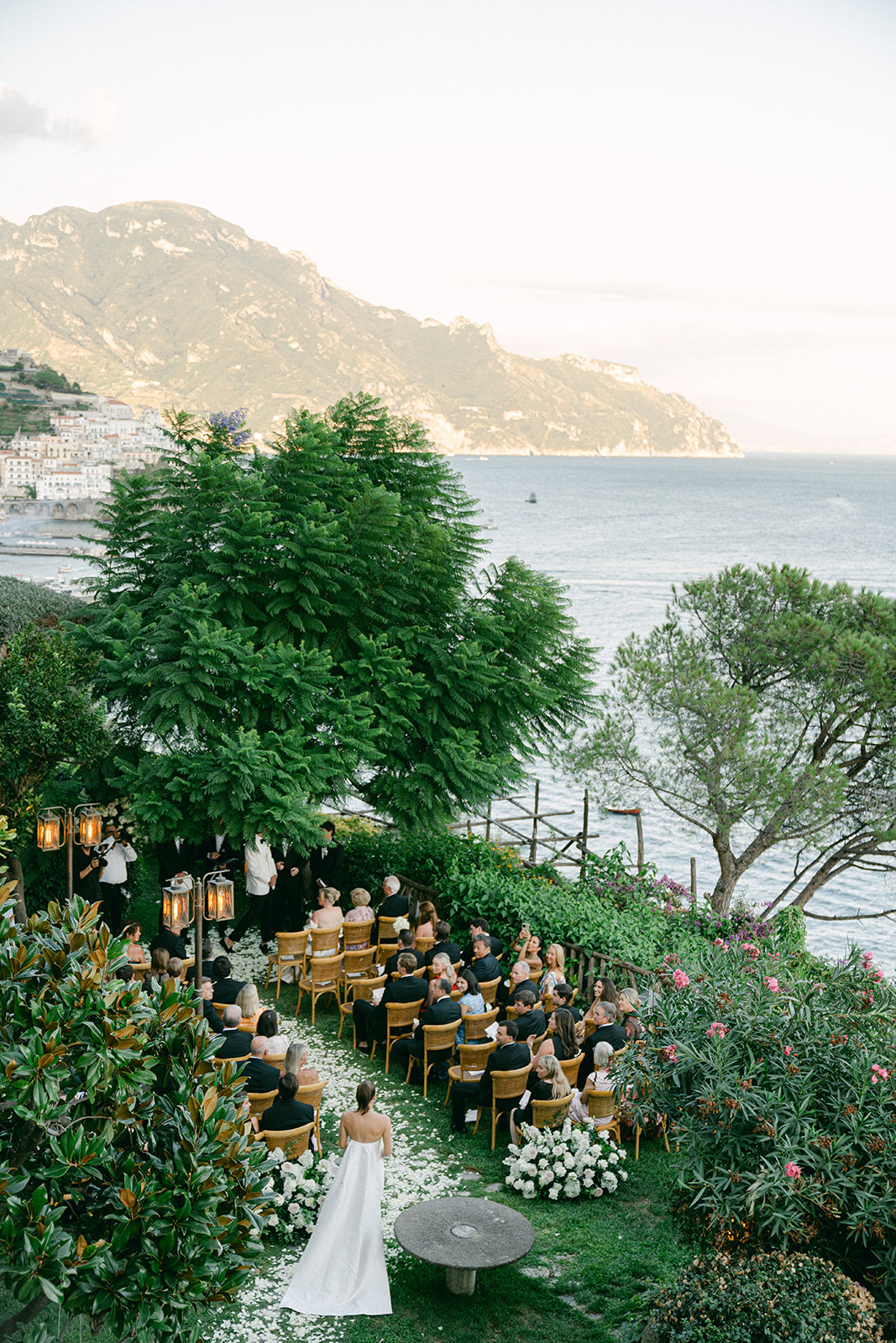 Outdoor wedding ceremony overlooking the Amalfi Coast with ocean views.