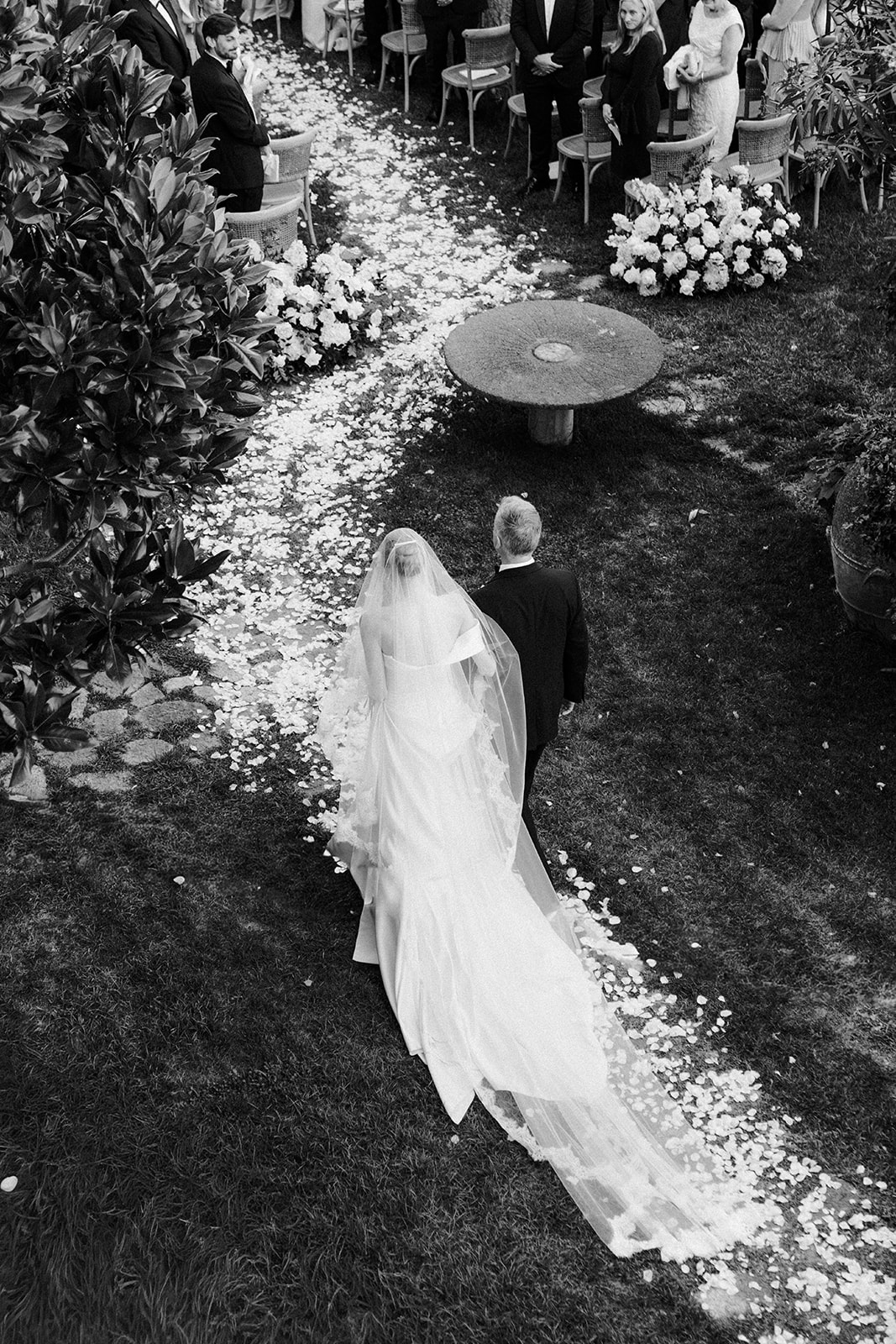 Bride walking down the aisle at a luxury coastal wedding in Italy.
