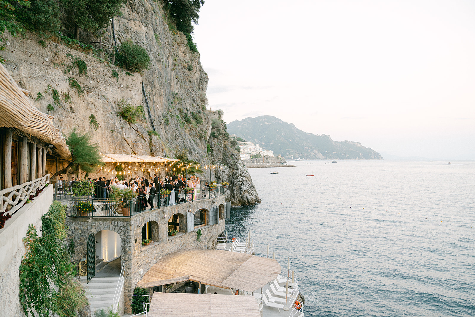 Lush floral canopy and candlelit tablescape at Italian wedding