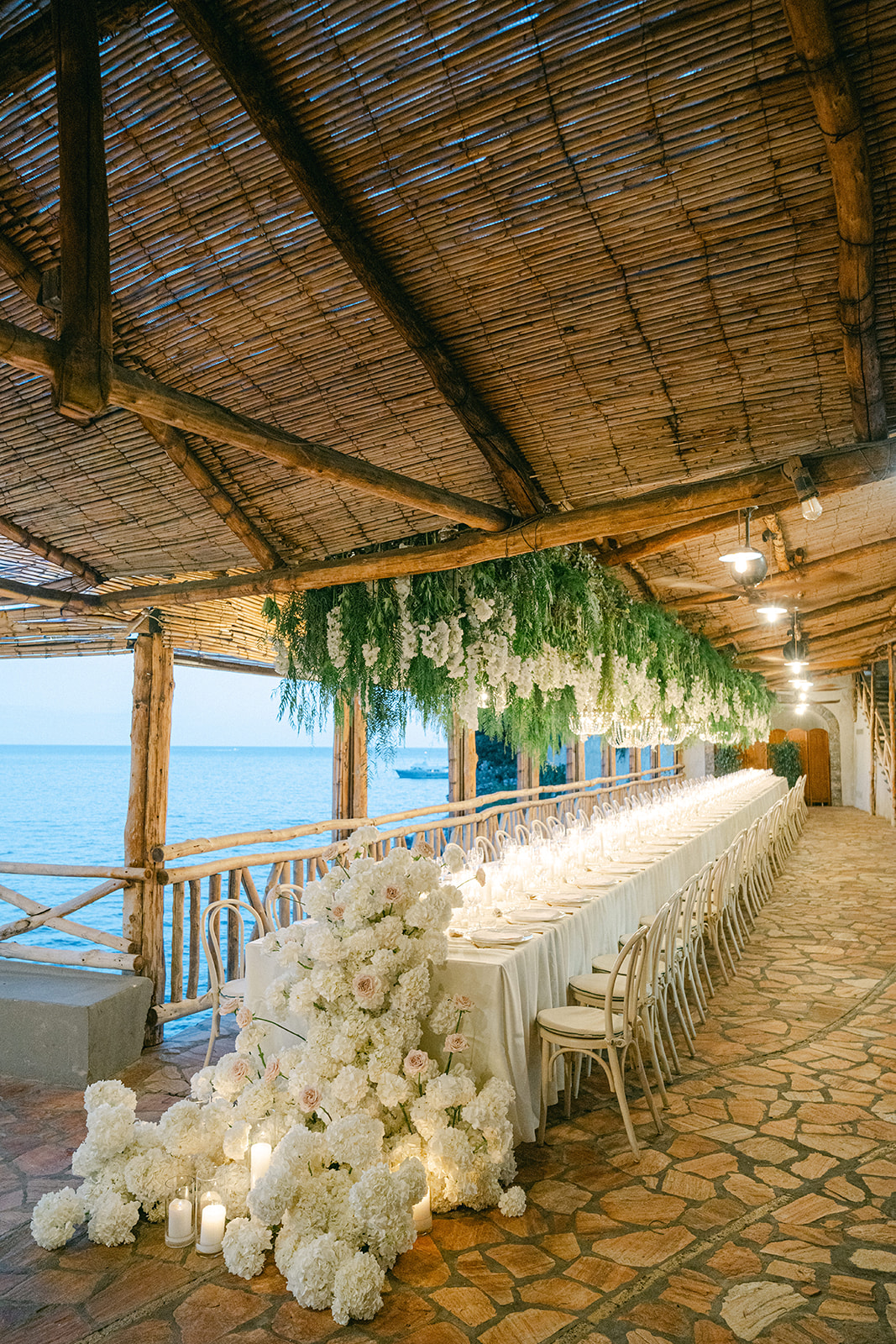 Romantic Italian coastal wedding with candlelit dinner table