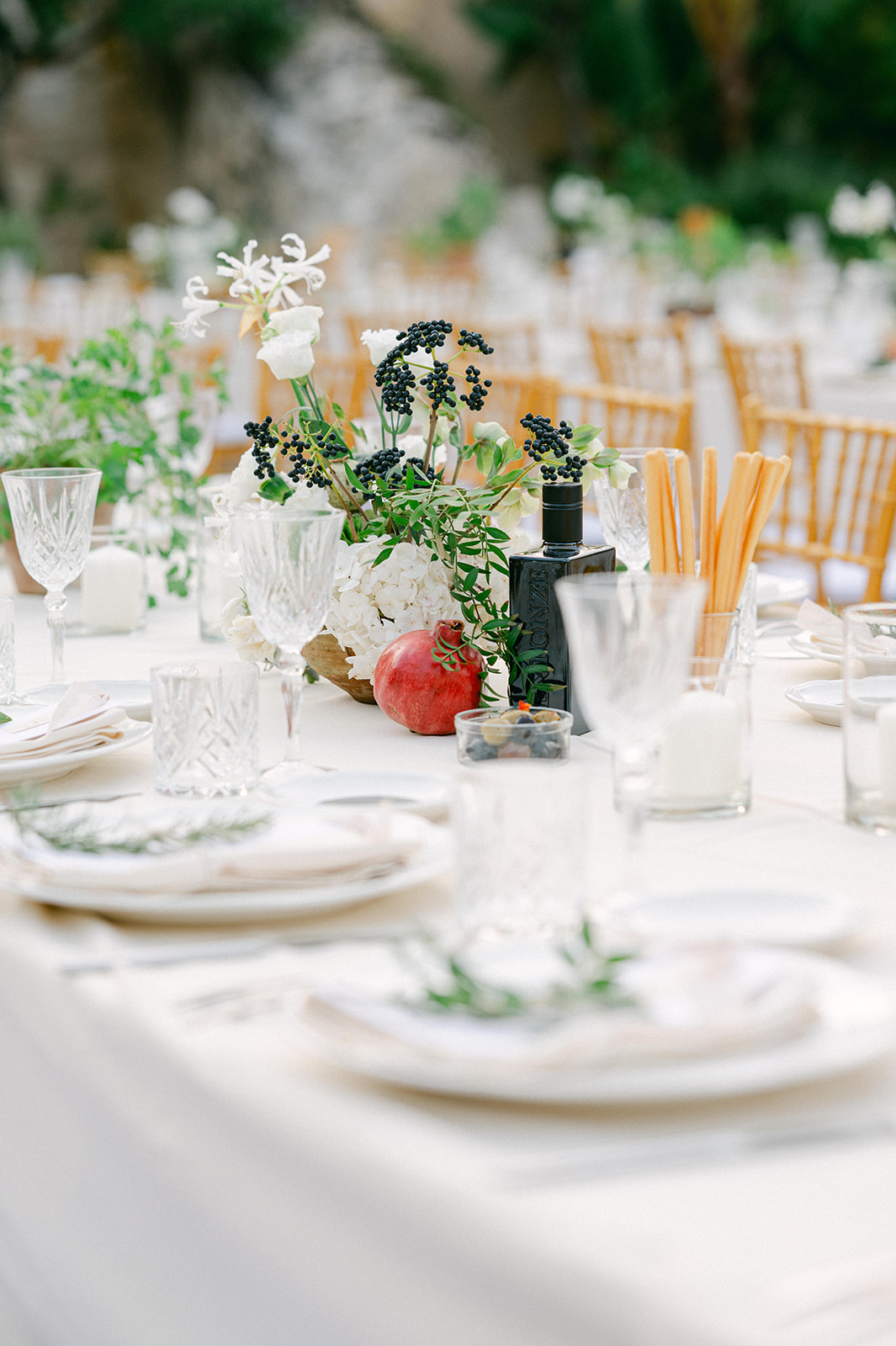 Close-up of the reception details with basil, rosemary, and simple neutral décor for an elegant wedding in Sicily.