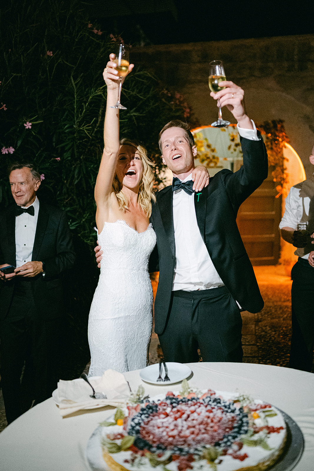 Bride and groom sharing a fun cake-cutting moment featuring the traditional Italian layered millefoglie dessert.