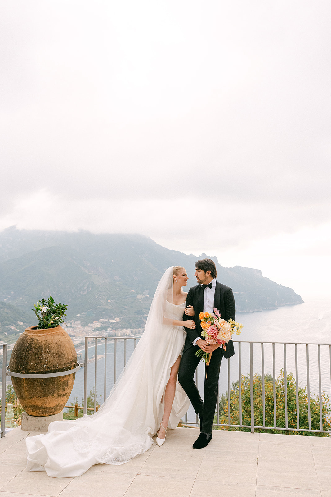 Bride and groom posing on private terrace at La Rondinaia