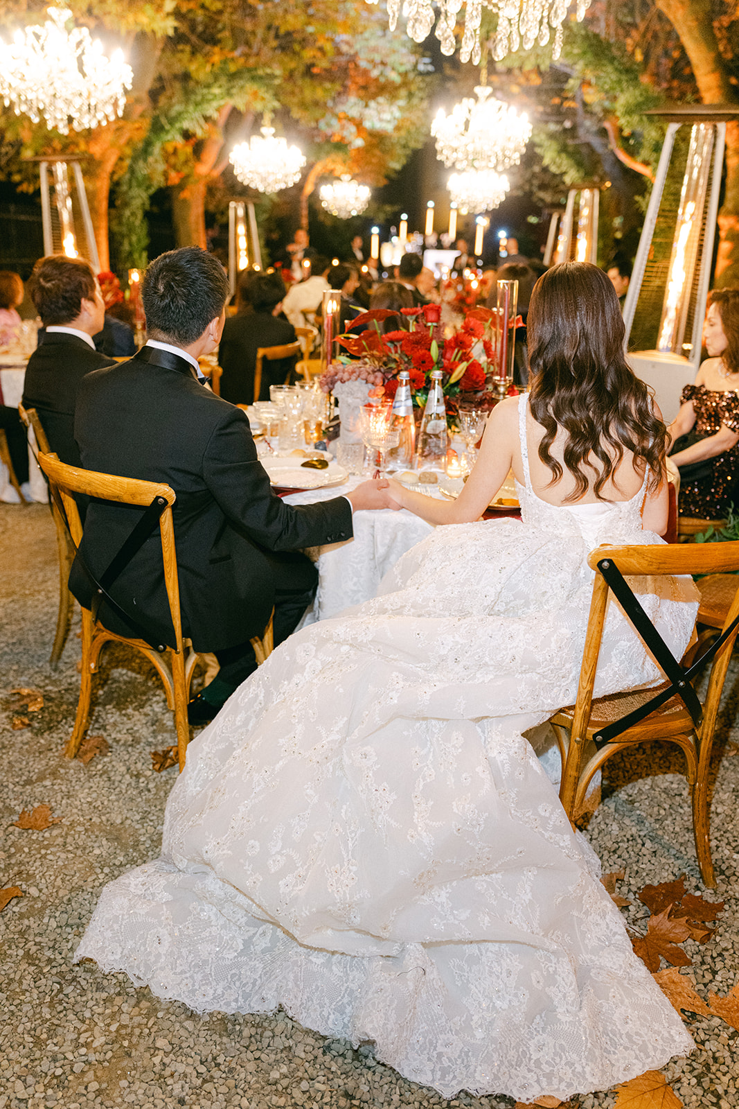 Autumn Tuscany wedding decor with jewel-toned florals and chandeliers