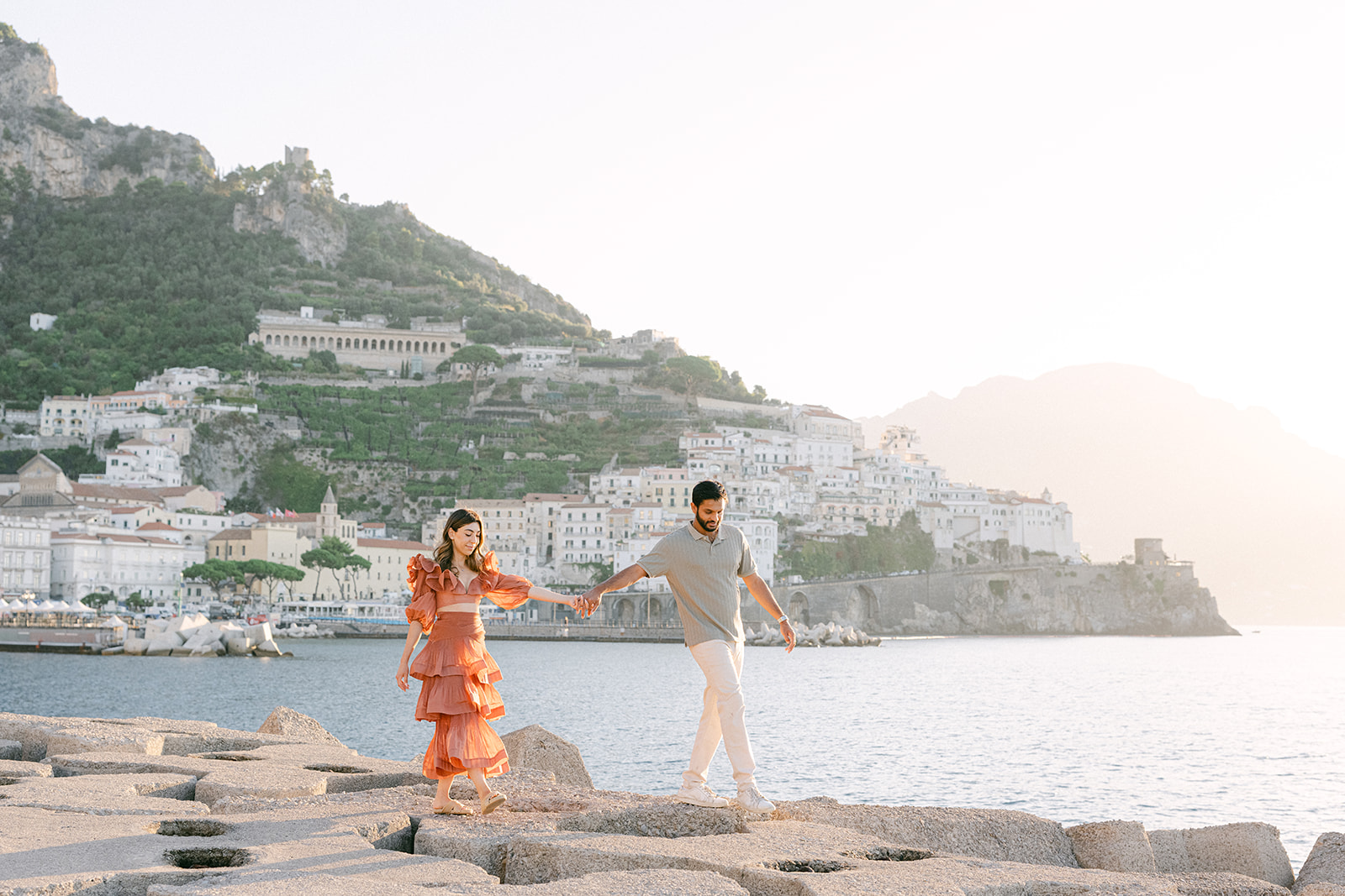 Couple embracing with sea views during an Amalfi Coast vacation photoshoot