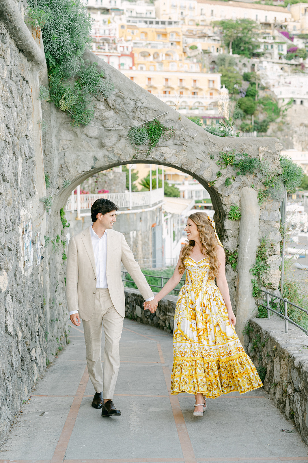 Couple walking through Positano streets during Amalfi Coast vacation engagement photos