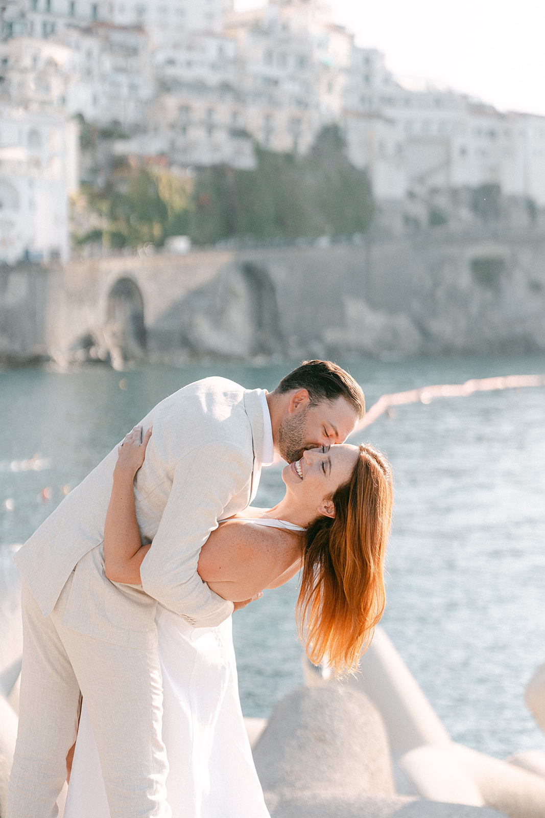 Couple enjoying sunset views over the Amalfi Coast during engagement photos