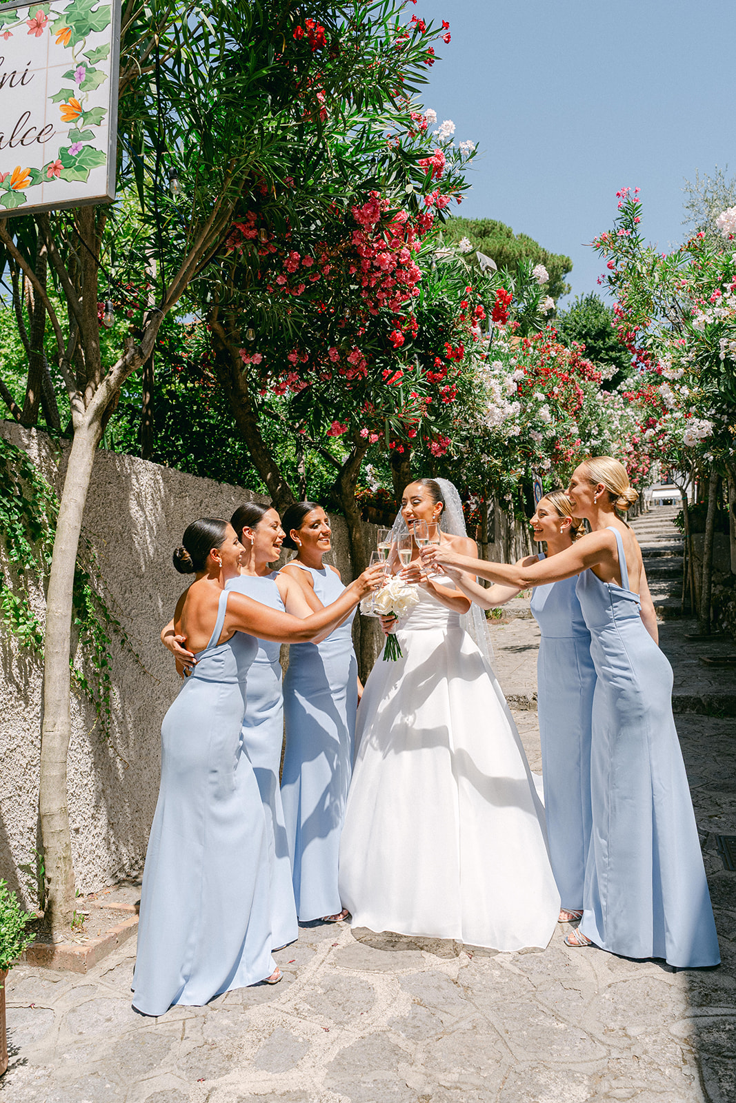 After getting ready wedding bride with champagne toast with bridesmaids