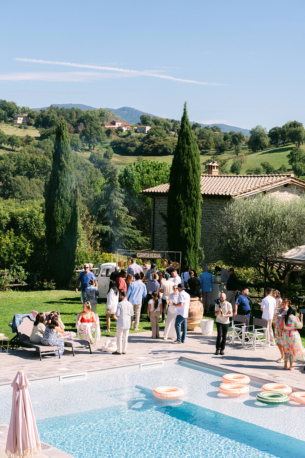 Relaxed poolside celebration following a luxury Tuscany wedding in Italy