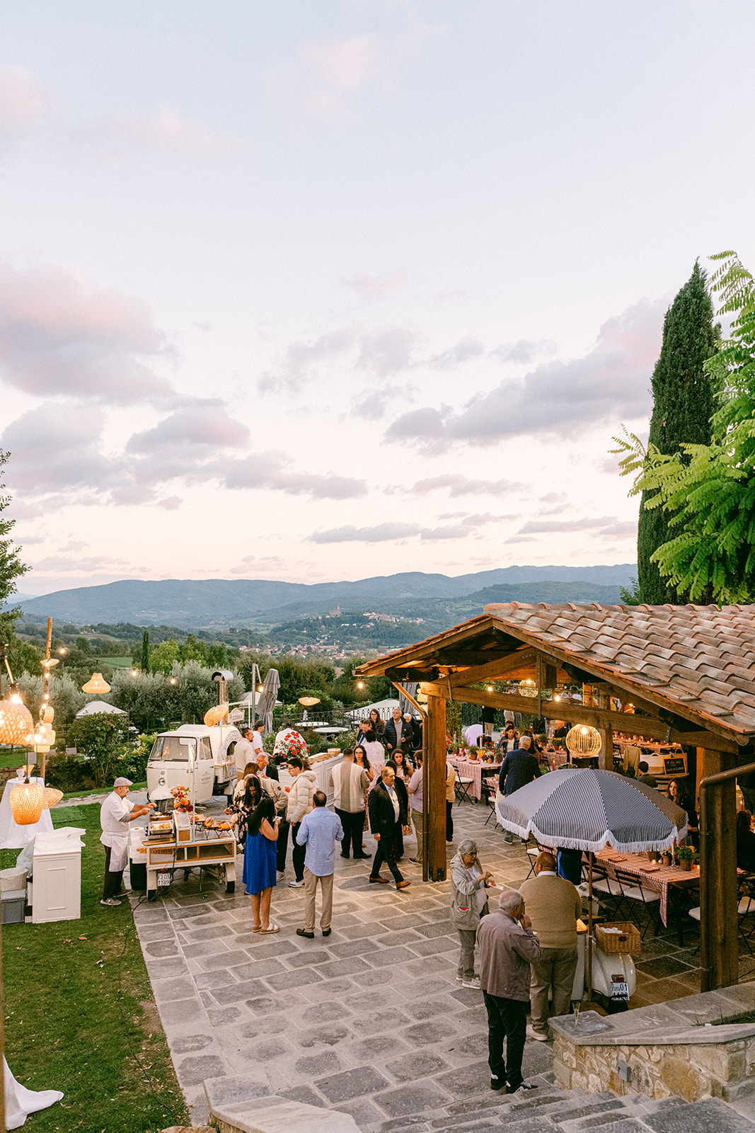 Guests enjoying a pizza party during a three-day Tuscany wedding celebration