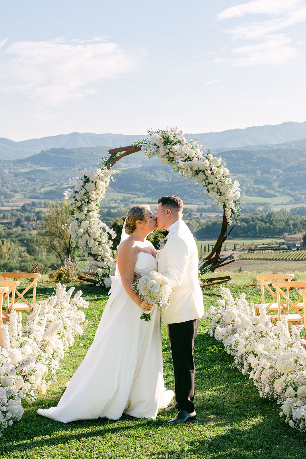 Outdoor garden ceremony during a luxury Tuscany wedding at Borgo Corsignano