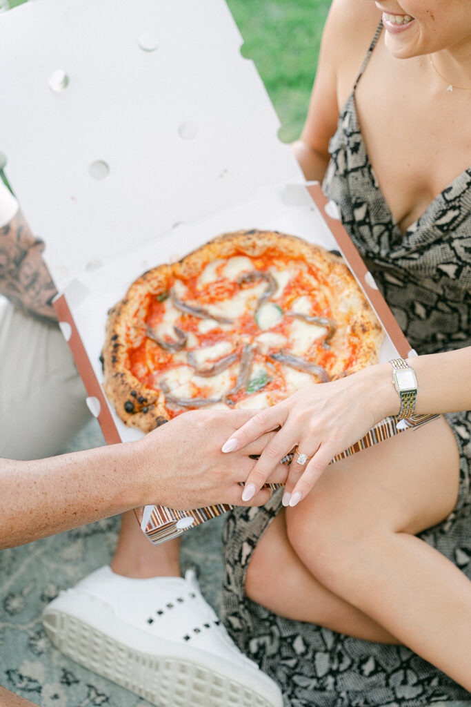 Couple celebrating engagement after a romantic picnic proposal