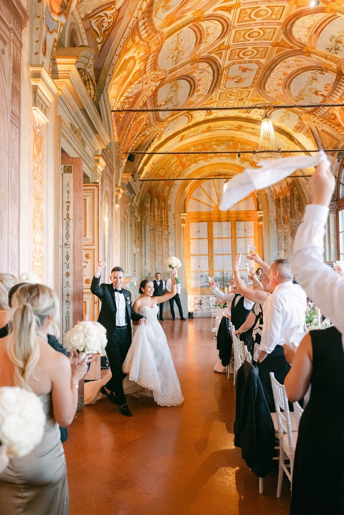 Bride and groom celebrating with their guests during an elegant Italian wedding reception