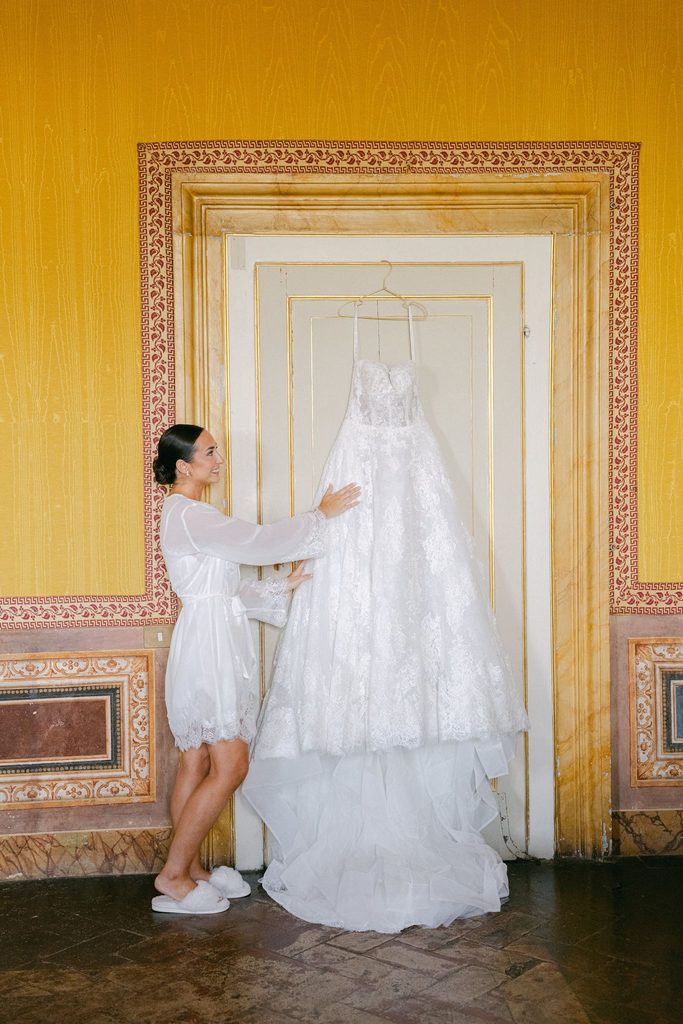 Candid bridal getting ready photography with her wedding dress in Tuscany