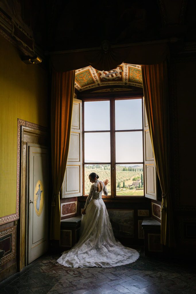 Bride in a romantic wedding gown posing for portraits at Villa Corsini near Florence